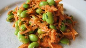 Carrot and edamame salad on a white plate